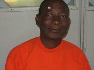 African man waits to undergo his first cataract surgery.