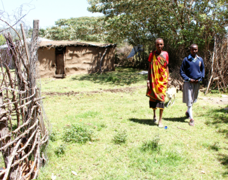 Kenyan mother and daughter on their farm with dog.