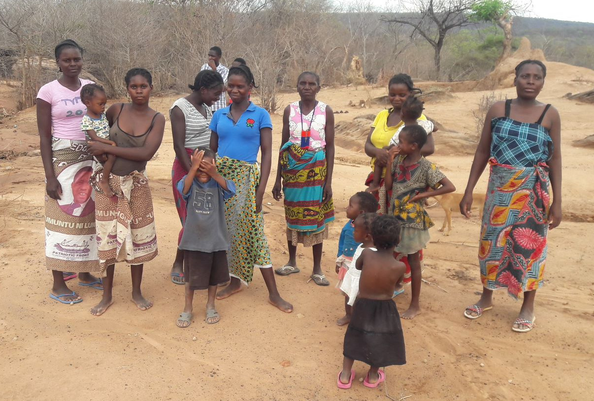 Women of Muuka village in Zambia watch as the water pump in their village is fixed.